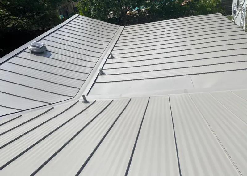 Solar attic fan installed on a metal roof for Roof Ventilation in Walworth